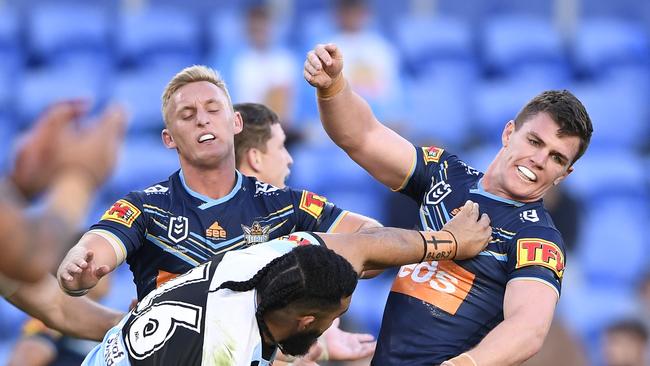 Siosifa Talakai of the Sharks fends off Beau Femor of the Titans. Picture: Ian Hitchcock/Getty Images