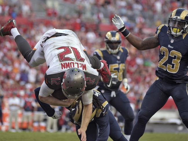Tampa Bay Buccaneers quarterback Josh McCown (12) is upended by St. Louis Rams cornerback Janoris Jenkins (21) as he dives over the goal line to score on a 1-yard touchdown run.