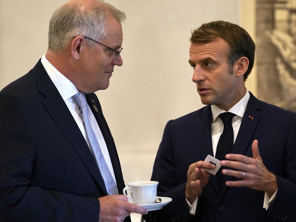 Australian Prime Minister Scott Morrison and French President Emmanuel Macron talk before the G20 leaders make a short visit to the Fontana di Trevi to throw a coin in the fountain to make a wish before the start of the second day of the G20 in Rome on Sunday, October 31, 2021. Picture: Adam Taylor
