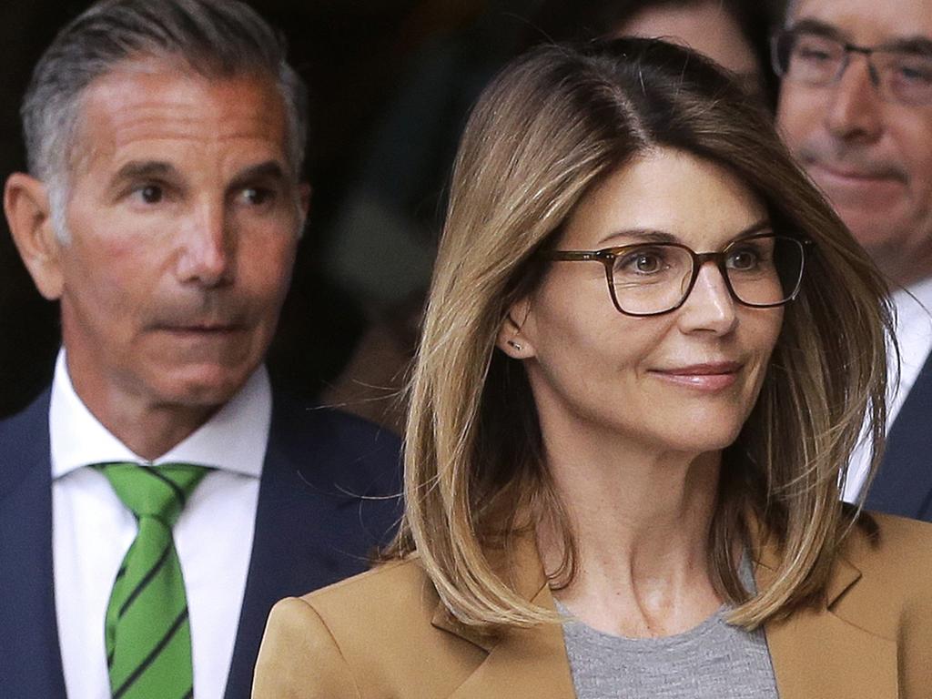 Lori Loughlin, right, with husband Mossimo Giannulli outside court. Picture: AP