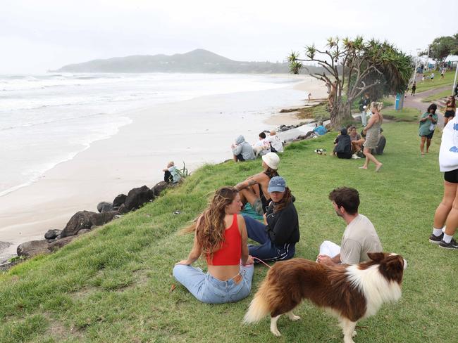 People gather on the foreshore at Byron’s Main Beach to watch the surf and surfers, Byron Bay. Picture: Rohan Kelly