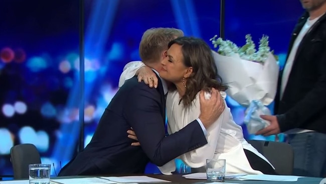 Lisa hugs co-host Hamish Macdonald.