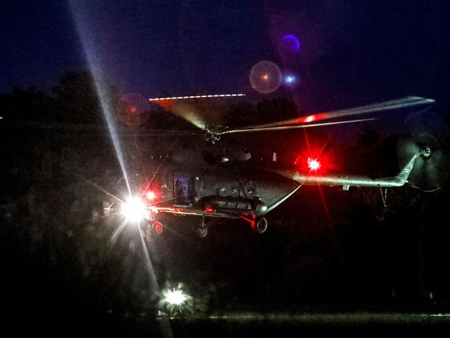 A helicopter lands at a military airport in Chiang Rai with its passengers taken by ambulance to nearby hospital. Picture: AFP