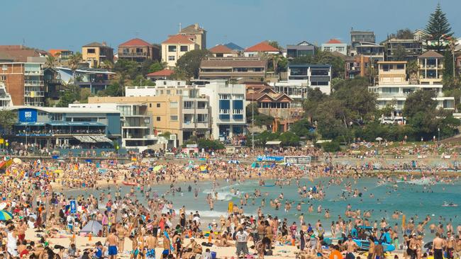 "Sydney, Australia - November 25, 2012: A large number of beach goers gather at the northern end of Bondi Beach on a hot Sunday afternoon." Australia crowds generic population