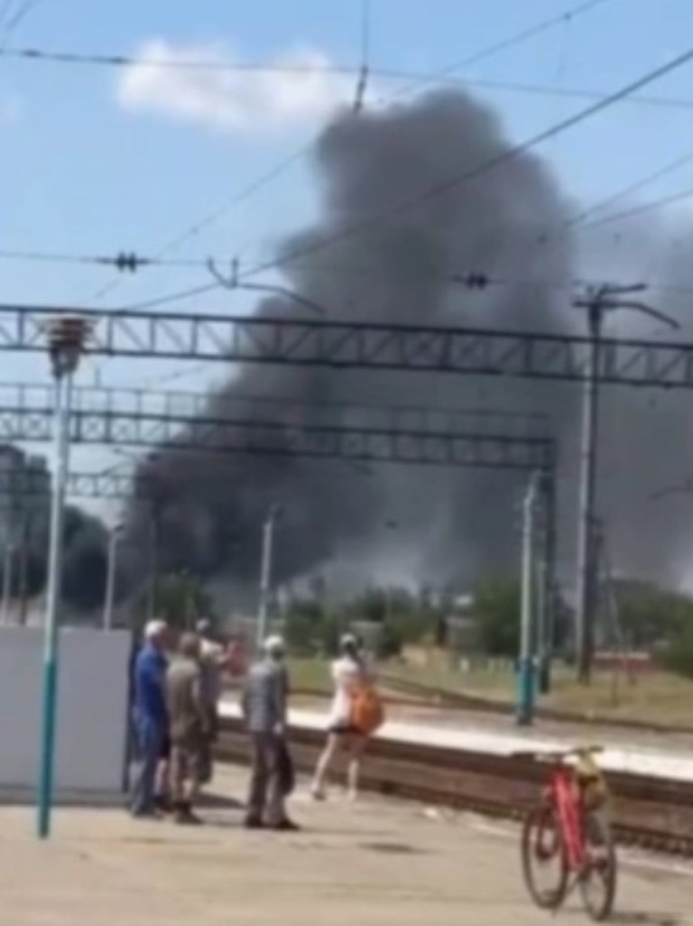 Locals stare in shock and horror as heavy black smoke fills the air. Picture: Twitter