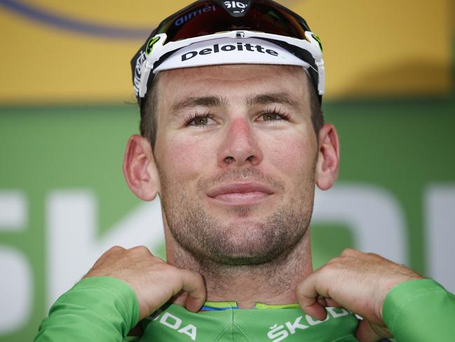 Stage winner Britain's Mark Cavendish puts on the best sprinter's green jersey on the podium after the third stage of the Tour de France cycling race over 223.5 kilometers (138.6 miles) with start in Granville and finish in Angers, France, Monday, July 4, 2016. (AP Photo/Christophe Ena)