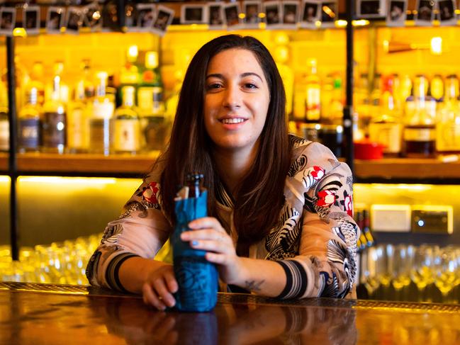 Jordana Clare-Kellett from Crooked Tailor in Castle Hill, Sydney NSW, with one of their Doss Blockos beers, $1 from every sale is donated to The Polished man campaign. The bar has painted its front door blue, and staff have painted one nail blue in support of The Polished Man Campaign, which aims to end violence against children. Friday 14th September 2018. (AAP Image/Jordan Shields)