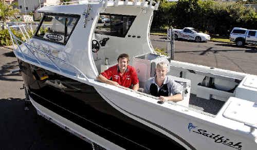 Sailfish Marine factory manager Craig Soward (left) and sales manager Ian Drew prepare the $140,000 2400 Gamefisher for the trip to the Sanctuary Cove International Boat Show that starts tomorrow. . Picture: jay cronan