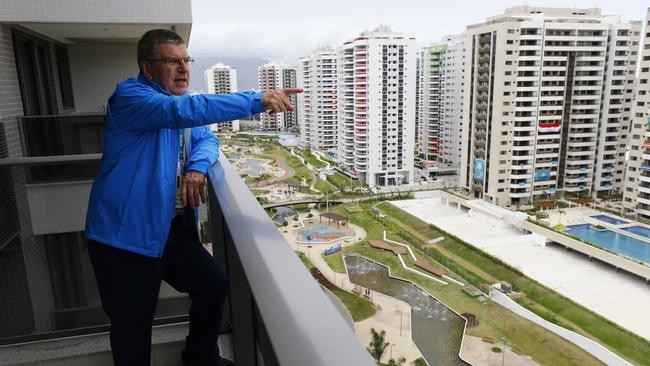 Tomas Bach, President of the International Olympic Committee surveys the Olympic village.