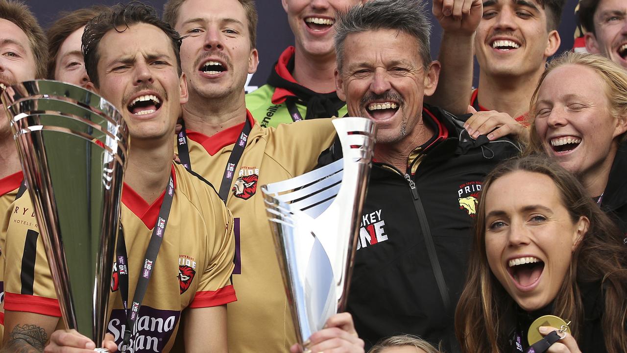 Players from the NSW Pride men's and women's teams celebrate together after the Hockey One League Grand Finals. Picture: Martin Keep/Getty Images