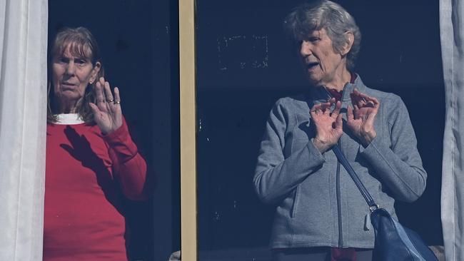 Residents wave from inside the SummitCare nursing home. Picture: NCA NewsWire/Bianca De Marchi