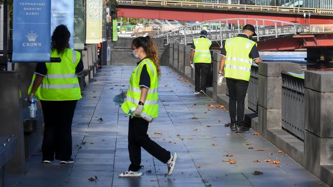 Cleaners wipe down surfaces throughout Melbourne city. Picture: AFP