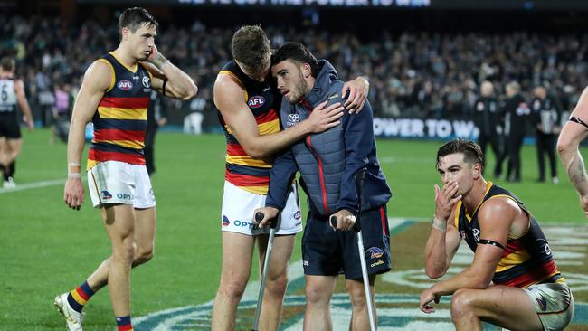 Brodie Smith consoles injured Crow Lachie Murphy post-game. Picture: Sarah Reed/AFL Photos/Getty Images