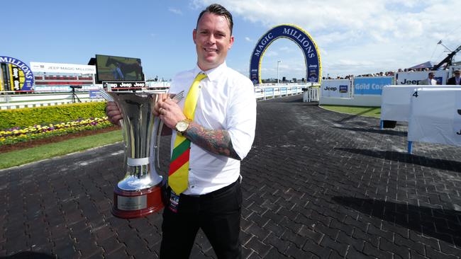 Byron Gall with the Magic Millions Cup trophy won by Lucky Hussler last year. Photo: Luke Marsden