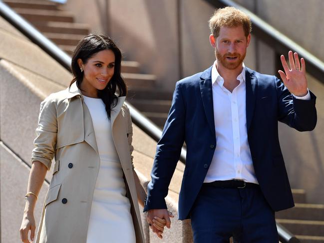 Prince Harry and his wife Meghan walk down the stairs of Sydney’s iconic Opera House to meet people in Sydney on October 16, 2018. Picture: Saeed Khan/ AFP