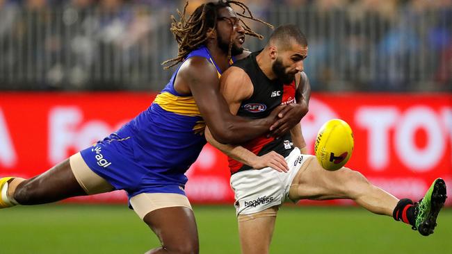 Nic Naitanui runs down Essendon’s Adam Saad.