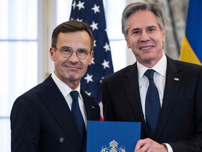 TOPSHOT - US Secretary of State Antony Blinken receives the NATO ratification documents from Swedish Prime Minister Ulf Kristersson during a ceremony at the US State Department, as Sweden formally joins the North Atlantic alliance, in Washington, DC, on March 7, 2024. Kristersson hailed his country's entry into NATO as a "victory for freedom," as it turned the page on two centuries of non-alignment following Russia's invasion of Ukraine. The accession "is a victory for freedom today. Sweden has made a free, democratic, sovereign and united choice to join NATO," he said at the ceremony. (Photo by ANDREW CABALLERO-REYNOLDS / AFP)