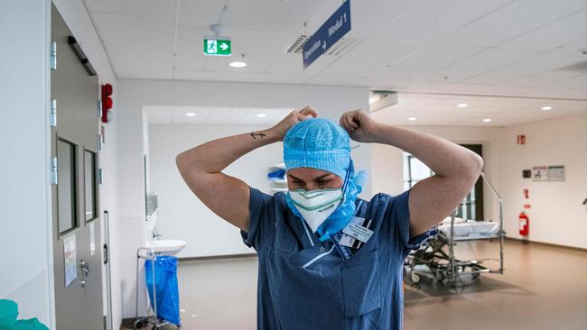 AÂ healthcare worker puts on protective gear as she prepares to treat patients infected with COVID-19 virus at the intensive care unit (ICU) in Stockholm's Sodersjukhuset hospital. Picture: Jonathan Nackstrand/AFP