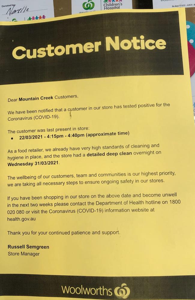 A sign at Mountain Creek Woolworths saying a customer who tested positive to COVID-19 visited the store. Queensland Health is yet to confirm.