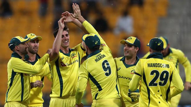 Patrick Cummins (3rd-L) celebrates with his teammates the dismissal of Haris Akmal. Picture: Mahmoud Khaled/AFP