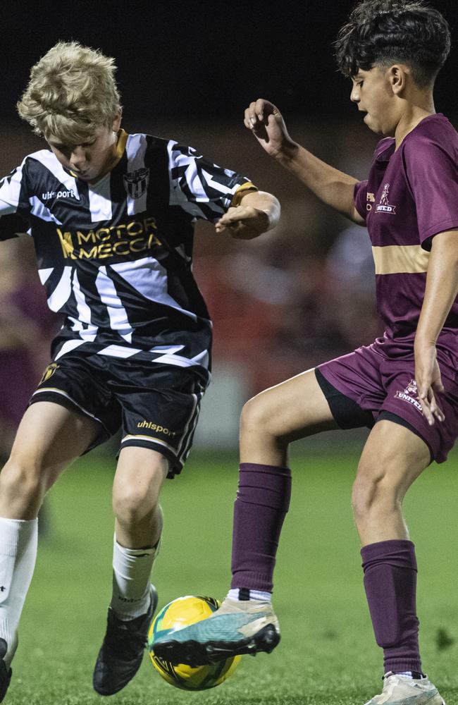 Judah Johnson (left) of Willowburn and Sol Ahmed of TAS United in Football Queensland Darling Downs Community Juniors U13 Junior League grand final at Clive Berghofer Stadium, Friday, August 30, 2024. Picture: Kevin Farmer