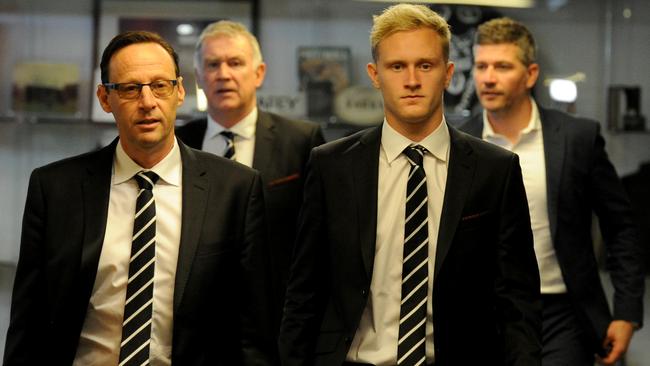 Jaidyn Stephenson walks into his press conference with Collingwood CEO Mark Anderson and football boss Geoff Walsh (back left). Picture: Andrew Henshaw