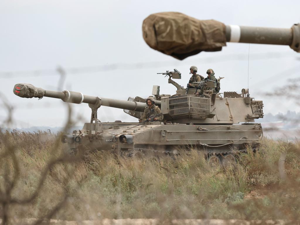 Israeli army soldiers are positioned with their armoured vehicles near the border with the Gaza Strip. Picture: AFP