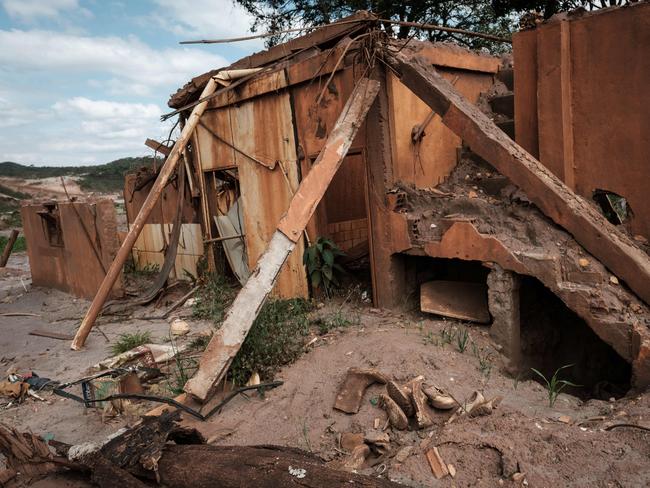 View at Bento Rodrigues village, ruined by the flood following the deadly collapse of the Samarco iron-ore mine dam last year, in Mariana of Minas Gerais State, Brazil, on October 26, 2016. Next November 5 marks the first anniversary of the burst of the iron ore waste dam of Samarco -owned by BHP Billiton and Vale SA- which killed nineteen people and destroyed the ecosystem of the Doce River in the worst mining accident in Brazil's history. / AFP PHOTO / YASUYOSHI CHIBA