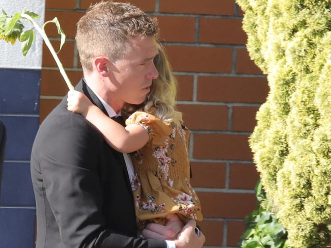 PERTH, AUSTRALIA - NewsWIRE Photos January 17th  2024: Rohan Dennis with daughter, and son behind, leaving Memorial Service to celebrate the life of his late wife Olympic cyclist Melissa Marie Dennis, at Fremantle Cemetery. Picture: NCA NewsWIRE/Philip Gostelow