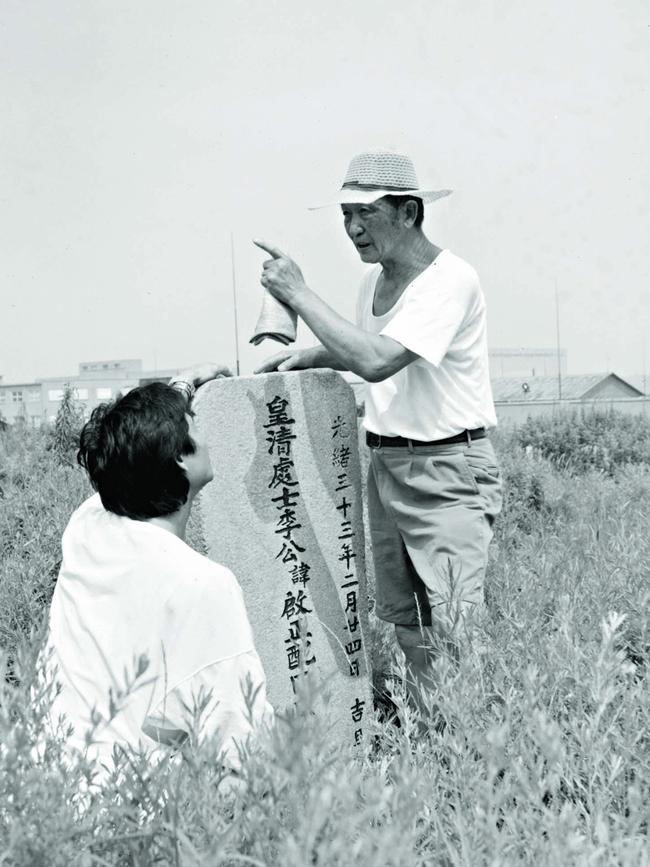 Li and his father Li Tingfang at an ancestor’s grave site, Li Commune (near Qingdao) in 1995. Picture: Li Cunxin