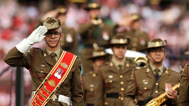 A member of the Australian Army Band salutes as the last post is played before the Roosters-Dragons clash. Picture: Getty