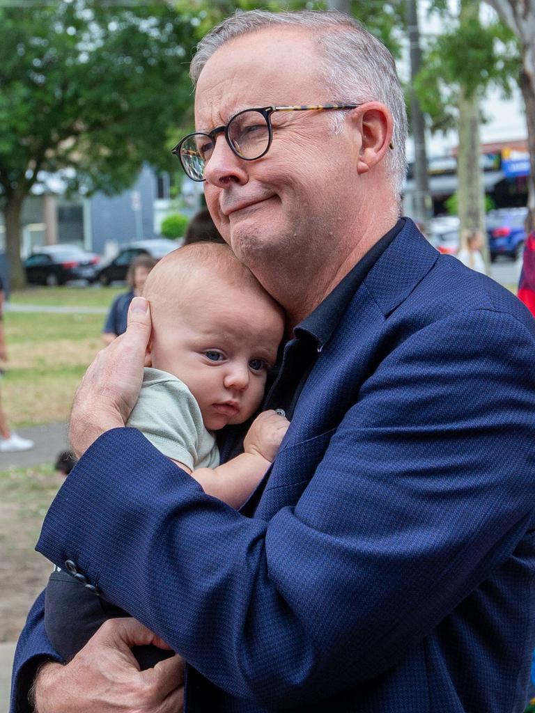 A baby appears content in the Prime Minister’s arms at Macleod. Picture: NCA NewsWire / Valeriu Campan