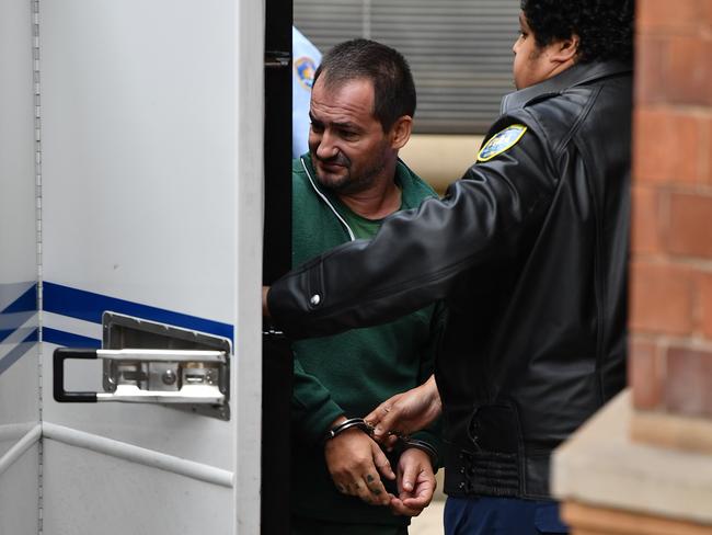 Zlatan Popovic is led to a prison van by Corrective Service Officers at the NSW Supreme Court in Sydney, Friday, November 17, 2017. In September, a NSW Supreme Court jury found Tevi Koloamatangi, 47, and Zlatan Popovic, 45, guilty of murdering Dragan Sekuljica, 28,  who was shot dead by the older man at Splashes nightclub early on September 8, 2007. (AAP Image/Joel Carrett) NO ARCHIVING