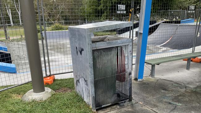 A burned out bin in front of the Thornlands skate park which has been fenced off for repairs after graffiti wrecked the surface. Picture: Supplied