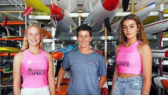 PADDLERS: Makaeli Adler, 15, Nirvana le roux, 16 and Kat Egan stand among surf skis at the Coolum Surf Club. Photo Patrick Woods / Sunshine Coast Daily.