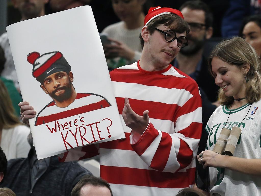 A Boston Celtics fan holds a sign asking about Irving