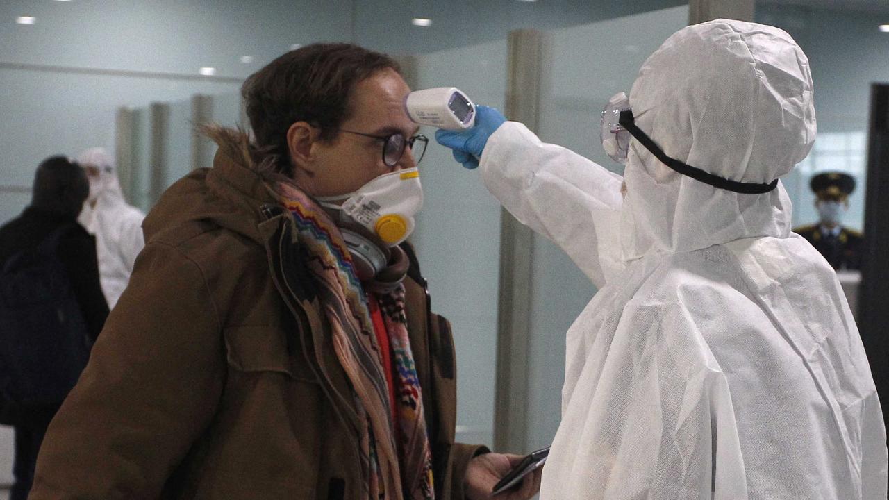 A passenger has his temperature checked before boarding a flight to Russia at the Pyongyang International Airport in Pyongyang, North Korea. Picture: AP Photo/Cha Song Ho