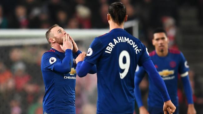 Wayne Rooney of Manchester United (C) celebrates.