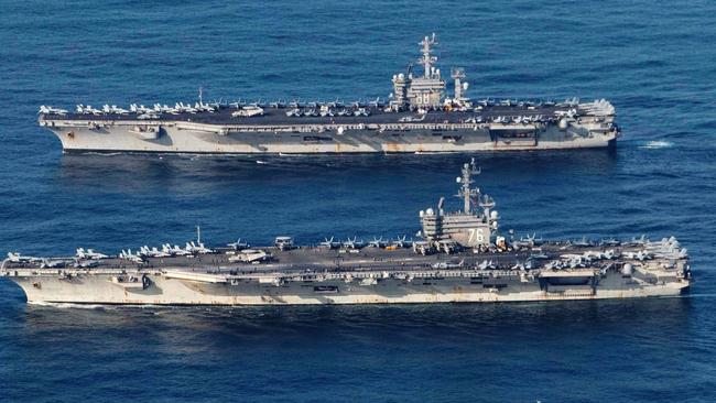 USS Ronald Reagan, bottom, and USS Nimitz have been involved in exercises in the South China Sea.