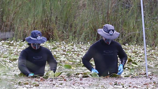 Police search for clues after the toolbox containing the pair’s bodies was lifted from Scrubby Creek.