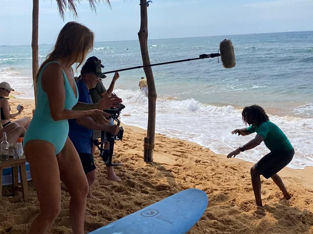 Filming surfing lessons with the crew and locals.