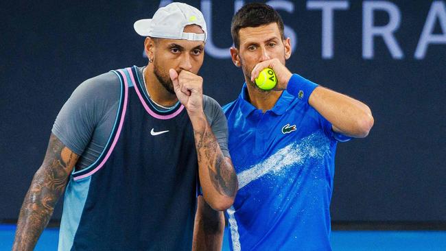 TOPSHOT - Serbia's Novak Djokovic (R) speaks with Australia's Nick Kyrgios before a point during their men's doubles match against Michael Venus of New Zealand and Nikola Mektic of Croatia at the Brisbane International tennis tournament in Brisbane on January 1, 2025. (Photo by Patrick HAMILTON / AFP) / --IMAGE RESTRICTED TO EDITORIAL USE - STRICTLY NO COMMERCIAL USE--