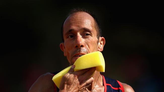 Yohann Diniz of France uses a sponge to cool off during the Men's 50km Race Walk