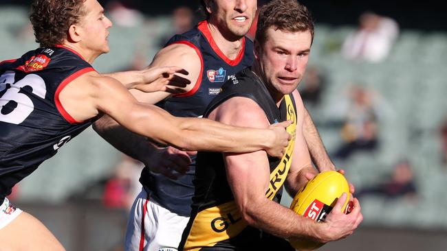 SANFL - 2nd match of a double header - Glenelg v Norwood at the Adelaide Oval. Tigers Andrew Bradley tries to get away from Norwood's Nick Pedro. Picture SARAH REED