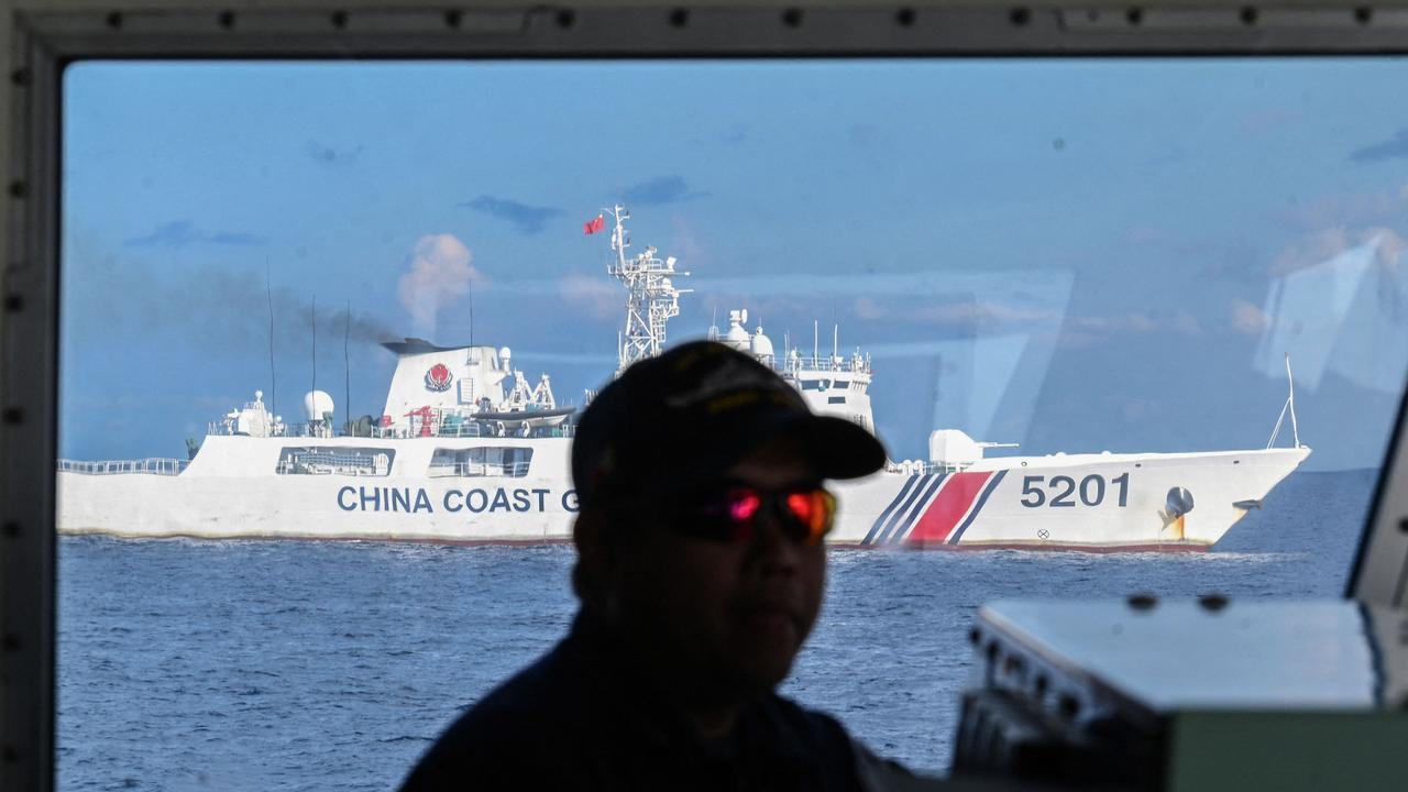 A member of the Philippine coast guard vessel BRP Malabrigo at his post while being shadowed by a Chinese coast guard ship at Second Thomas Shoal. Picture: Ted Aljibe/AFP