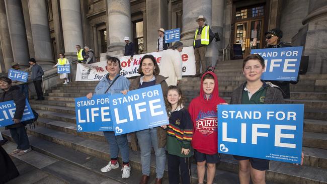 Rose Luppino with Francis Evans and her children Liberty, 8, John, 10 and George, 11 at A Rally on the steps of Parliament House by those against the euthanasia bill, 26 May 2021. Picture Simon Cross