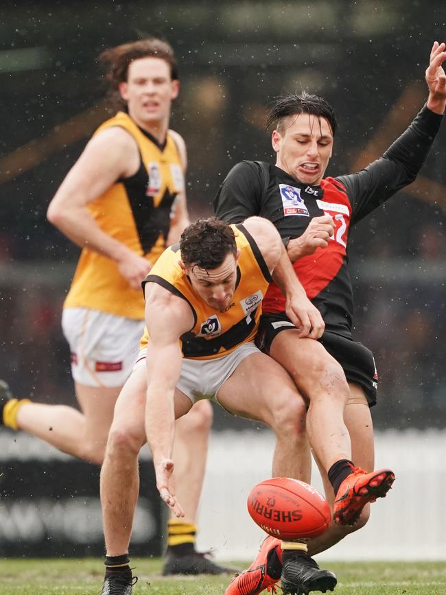 Tom Gribble gathers possession under pressure from Mark Baguley. Picture: AAP Image/Michael Dodge.