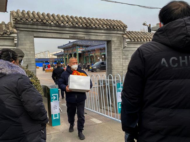 A man carries an urn of a loved one's ashes at a crematorium in Beijing. Picture: AFP