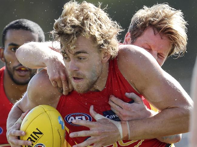 AFL - Adelaide Crows v Gold Coast at Noarlunga Oval. Hugh Greenwood under pressure from Rory Sloane Picture SARAH REED