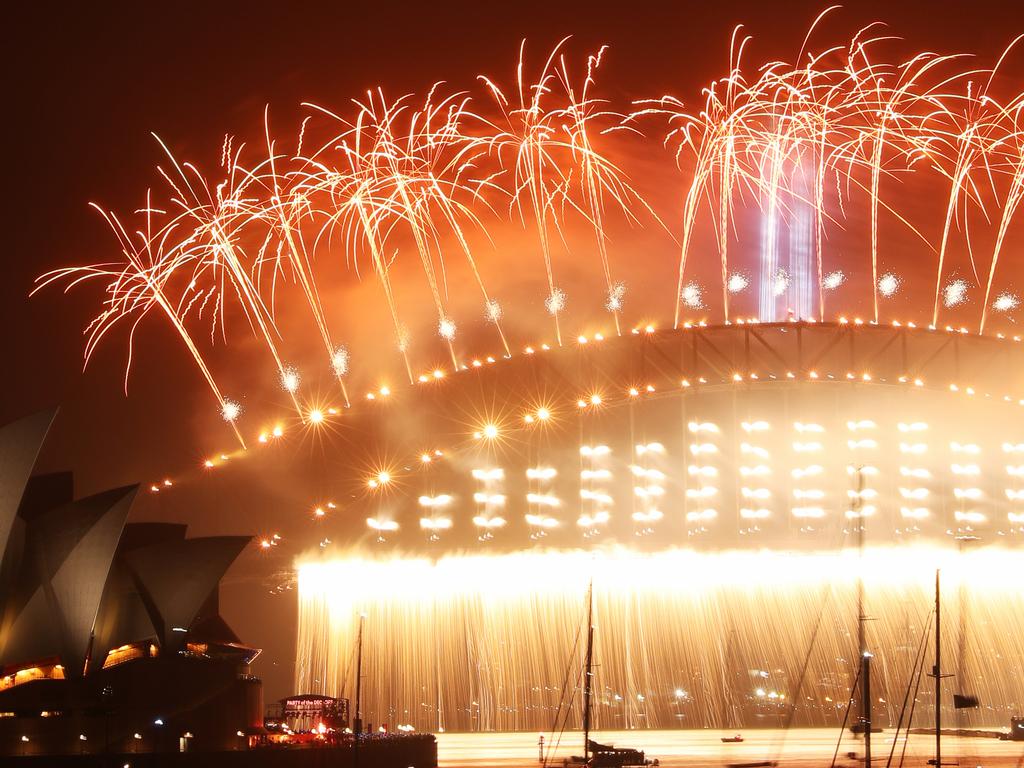 The harbour bridge lights up for the Midnight fireworks display, New Years Eve Fireworks on the Sydney Harbour Bridge as seen from Mrs Macquarie's Point 2019. Picture Rohan Kelly